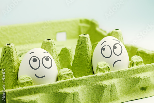 Two eggs in eggbox. Optimist and pessimist