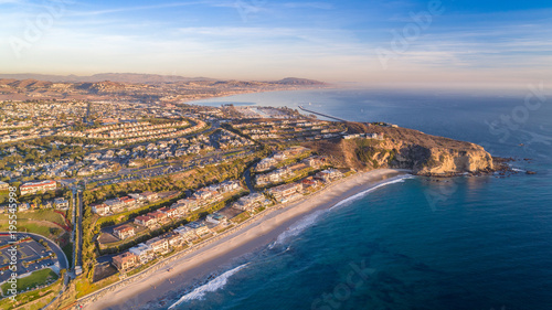 Aerial view of the California coast and ocean in Dana Point, Orange County on a sunny day with the harbor in view.
