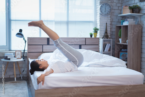 Asian women exercising in bed in the morning, she feels refreshed.She acted plank