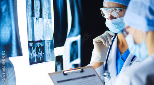 Two female women medical doctors looking at x-rays in a hospital.