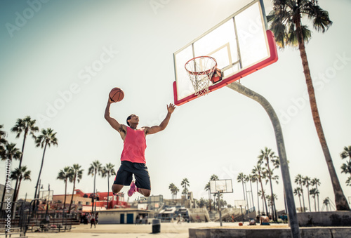 Basketball slam dunk on a californian court