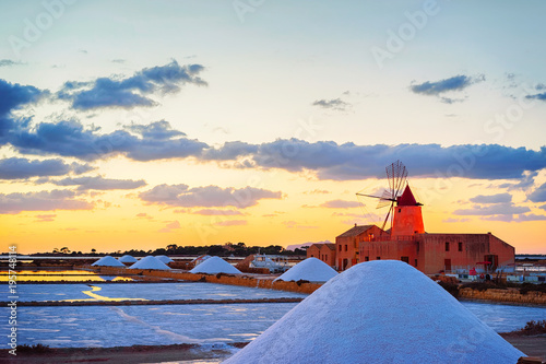 Sunset at Windmill in salt evoporation pond at Marsala Sicily