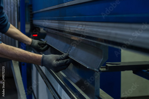 operator working cut and bending metal sheet