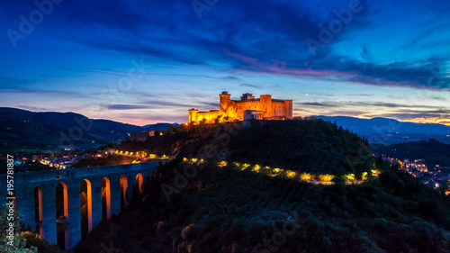 Sunset over the highlighted castle in Spoleto, Italy
