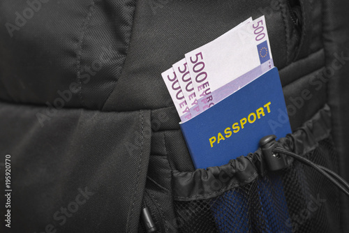 A backpack from whose pocket a passport and money are sticking out in euros. Concept of travel