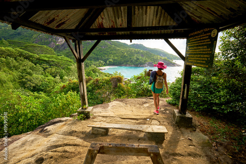Anse major trail, a woman hiking on nature trail of Mahe, in order to view anse major beach Seychelles