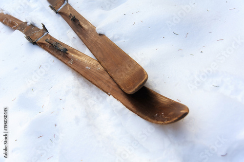 Photo of vintage old wooden skis on the terrace of a country house