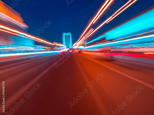 Speed motion on the neon glowing road at dark.
