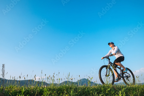 Woman ride a bike: summertime activity