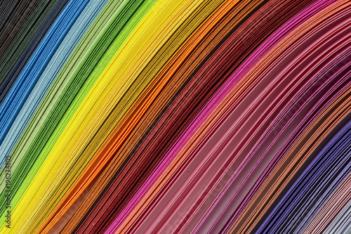 Multicolored quilling paper curved stripes forming a bright background. quilling rainbow colors, close-up, Colorful abstract lines for background. 