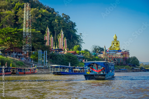 Outdoor view of a group of tourists in a tourist boat visiting the golden budha located at golden triangle Laos