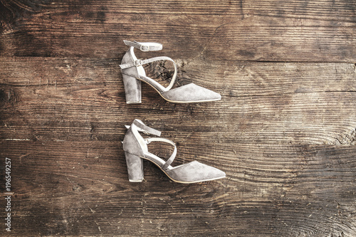 Suede female shoes on wooden background
