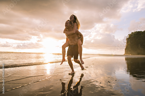 Couple in love having romantic tender moments at sunset on the beach