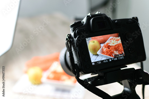 Concept image - rear view of DSLR camera making a food photography in the photo studio