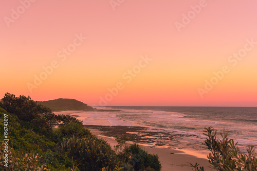 The Pinky sunset in summer time on the beach in Ballina with ocean view and hilly landscape, Byron bay, Australia