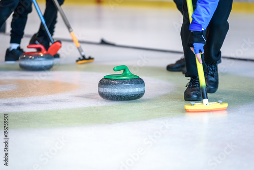 Team members play in curling at the championship.