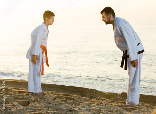 Man and boy exercising karate