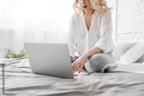 Woman Typing on Laptop at Home