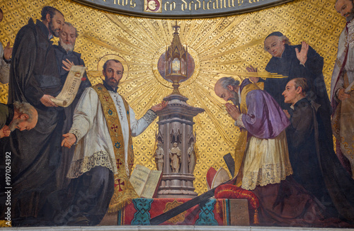TURIN, ITALY - MARCH 15, 2017: The symbolic fresco of The adoration of holys in front of Eucharist in church Chiesa di San Dalmazzo by Enrico Reffo (1831-1917).