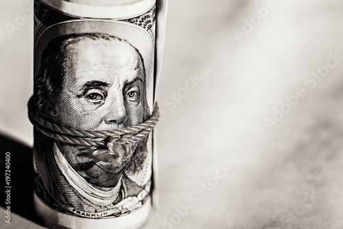 the wad of hundred dollar bills, Benjamin Franklin, twisted and tied, with a rope.