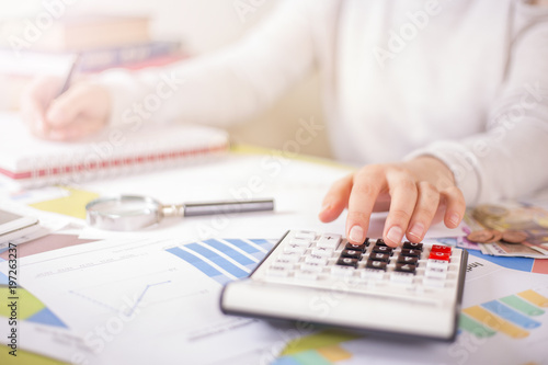 woman is doing calculations on office desk