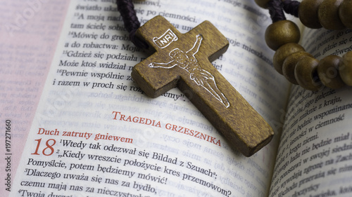 cross from rosary on the polish bible - Book of Job, tragedy of the sinner