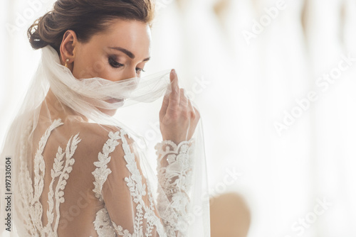 Stylish bride in lace dress in wedding salon