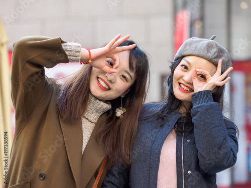 Cute positive portrait of best friend pretty young girls, natural glowing makeup, Two young hipster girl sisters having fun and making faces together.