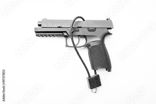 Locked disarmed secured handgun white background