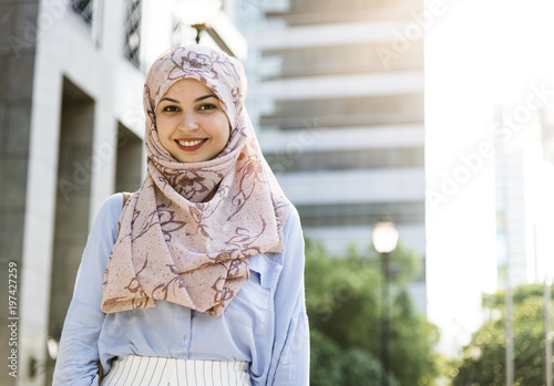 Islamic woman standing and smiling in the city