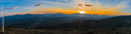Colorful bright sunset in the mountains, panoramic photo
