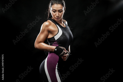 A strong athletic, woman on black background wearing in the sportswear, fitness and sport motivation.
