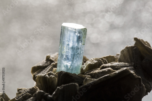 Close-up shot of an aquamarine crystal on dark background