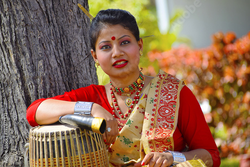 Assamese girl In traditional attire posing with A Dhol, Pune, Maharashtra.