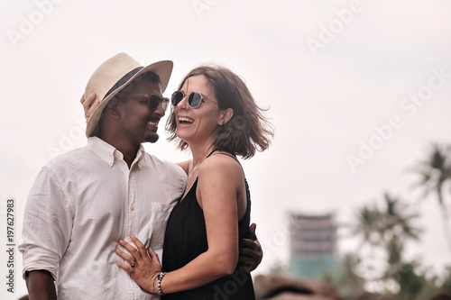 Lovely couple on tropical beach. Concept of just married lovers. They are happy to be together