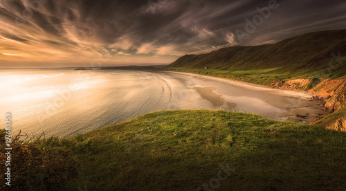 Sunset at Rhossili Bay on the Gower peninsula, Swansea, South Wales, UK, voted one of the top ten best beaches in Britain 