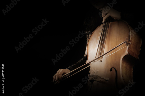 Cello player. Cellist hands playing cello with bow