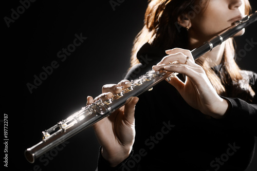 Flute instrument. Flutist hands playing flute music