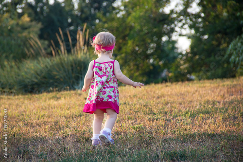 little girl is walking in the park