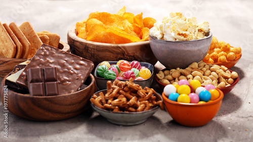 Salty snacks. Pretzels, chips, crackers in wooden bowls.