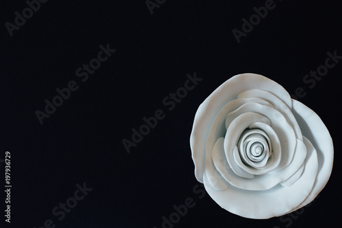 Tiny white handmade flowerbud on black background