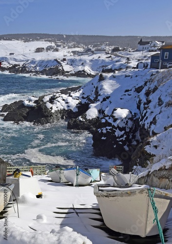 small fishing boats tied up on dry dock on a steep slope along the rugged coastline in Pouch Cove Newfoundland, Canada