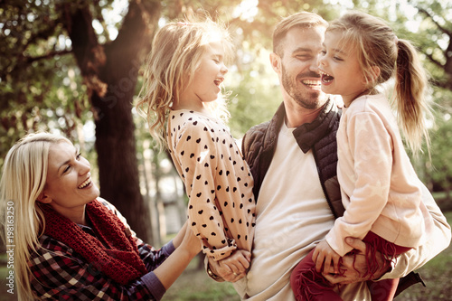 Cheerful family together in park enjoying in nature.
