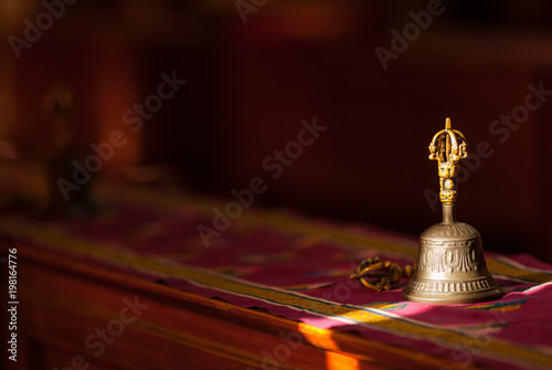Ritual hand bell in the Buddhist temple as the enlightenment symbol, has got to a sunlight beam.