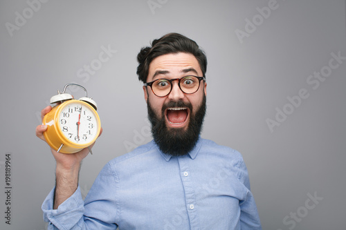 Scared man with alarm clock