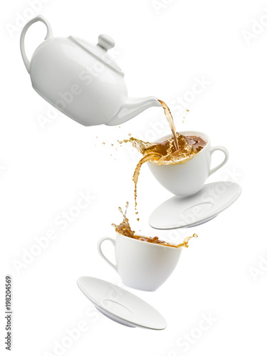 teapot pouring tea into flying cups, on white background