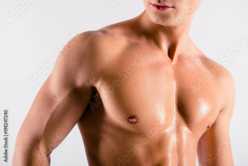 Close up cropped front view photo of sexual tempting attractive tired sporty muscular sweaty man's pectoral muscles, isolated on white background