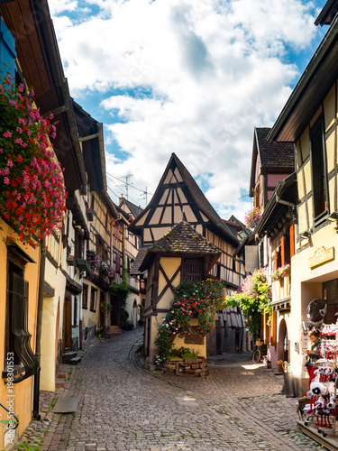 Beautiful view of the historic town square of Eguisheim, a popular tourist destination along the famous Alsace Wine Route, on a sunny day with blue sky, Alsace, France