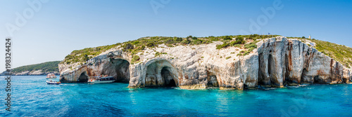 Tourist boats close to Blue caves at the cliff of Zakynthos island with, Greece, Panorama view