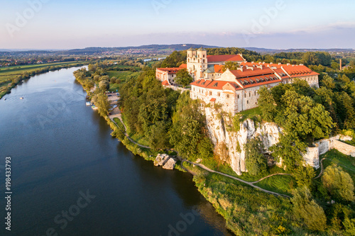 Benedictine monastery on the rocky cliff in Tyniec near Krakow, Poland, and Vistula River. Aerial view at sunset